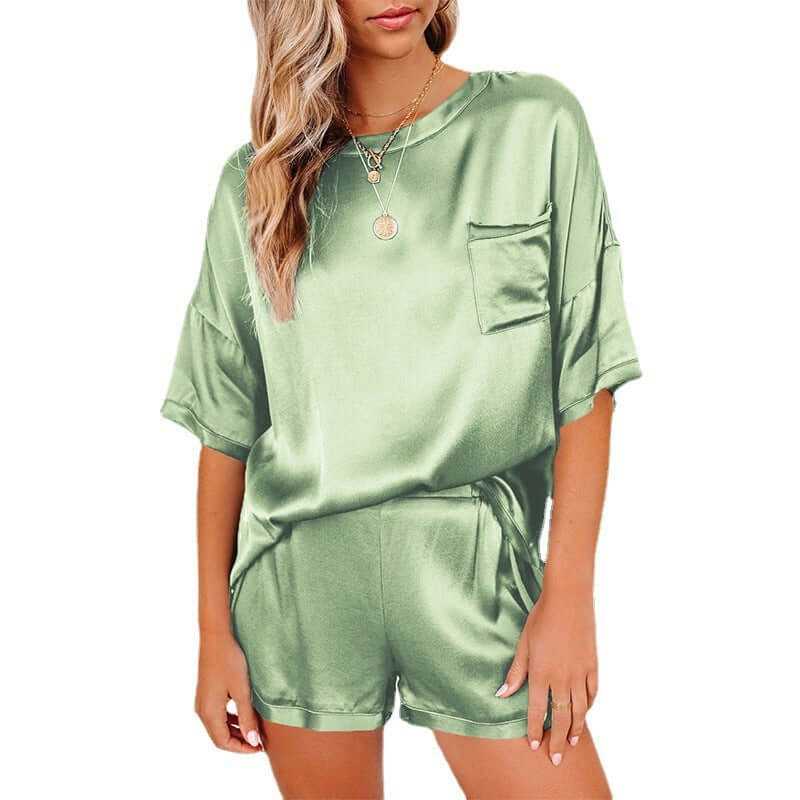 Women's short sleeve silk pajama set in green, featuring a relaxed T-shirt and shorts, perfect for home leisure wear.