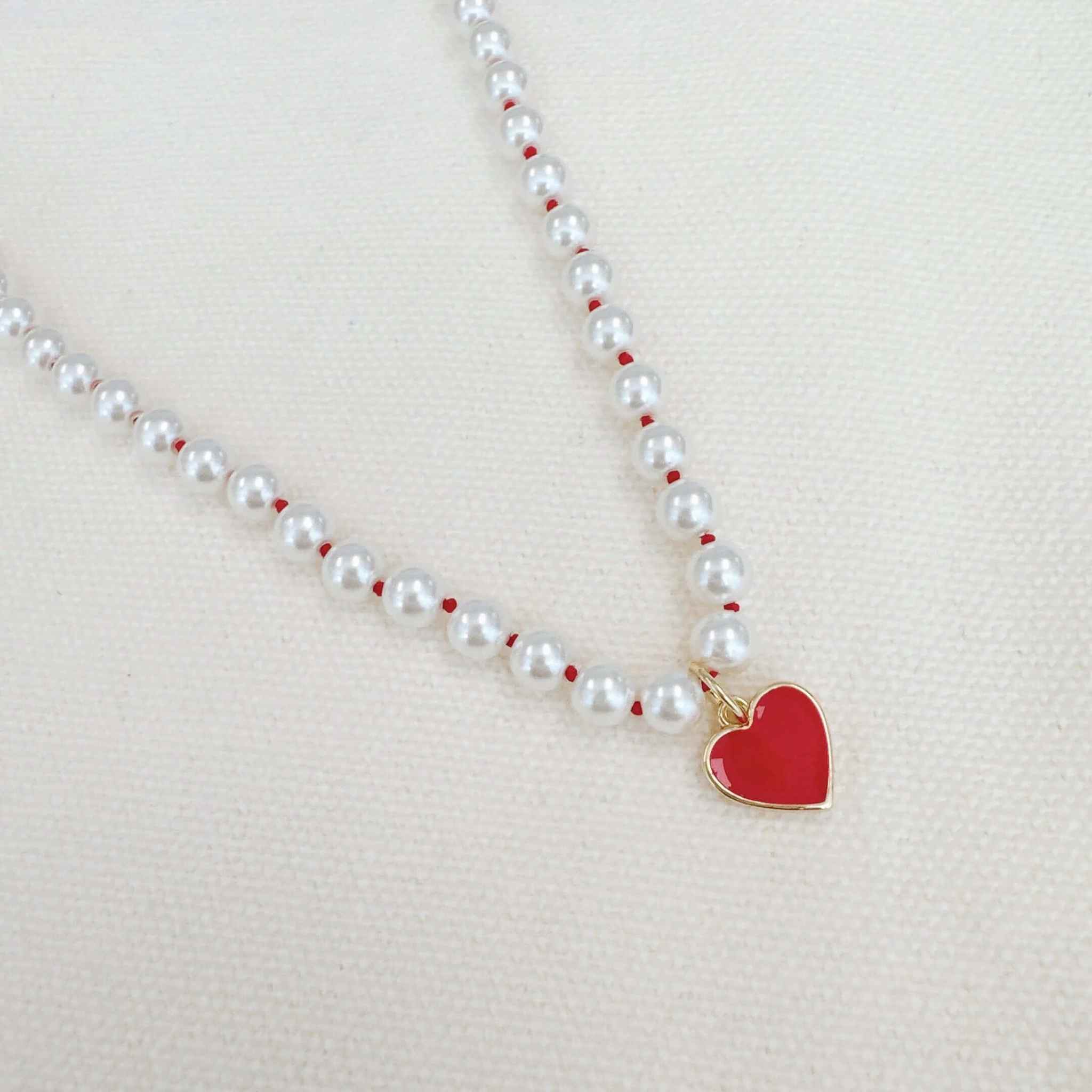 Silky adjustable thread heart pendant necklace with red heart charm and pearl beads for a chic look.