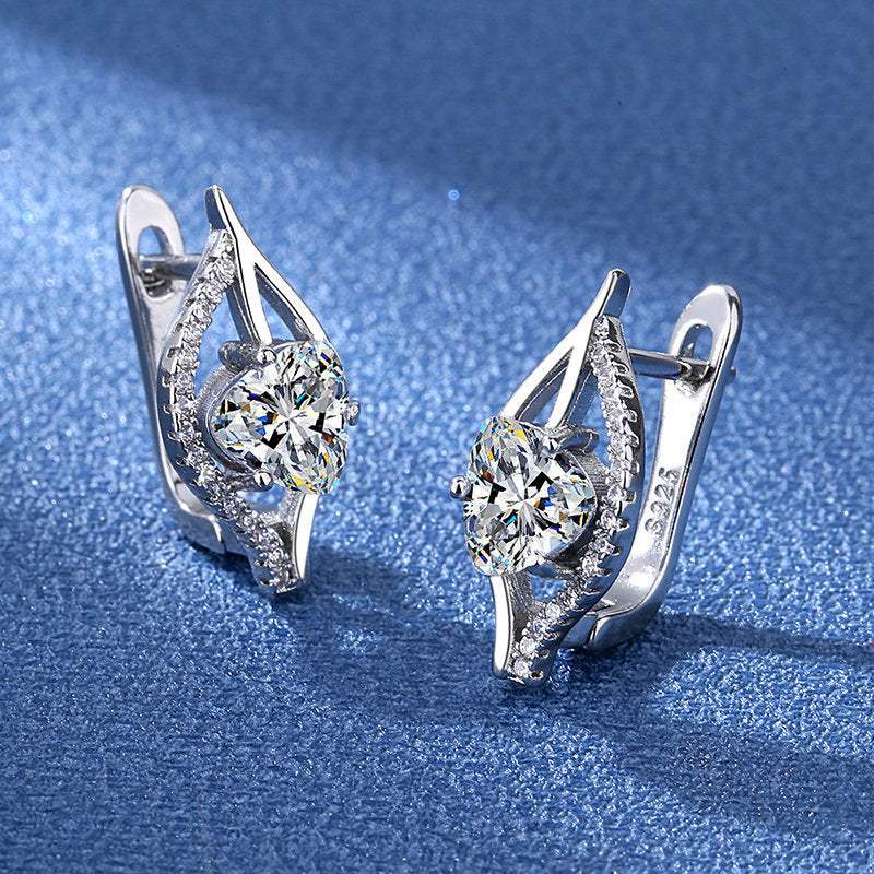 Simple and stylish silver plated heart shape earrings with cubic zirconia on blue background