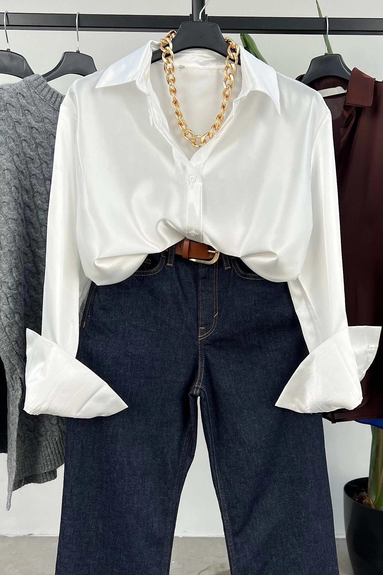 White single-breasted long sleeve lapel shirt styled with denim jeans and a statement necklace.