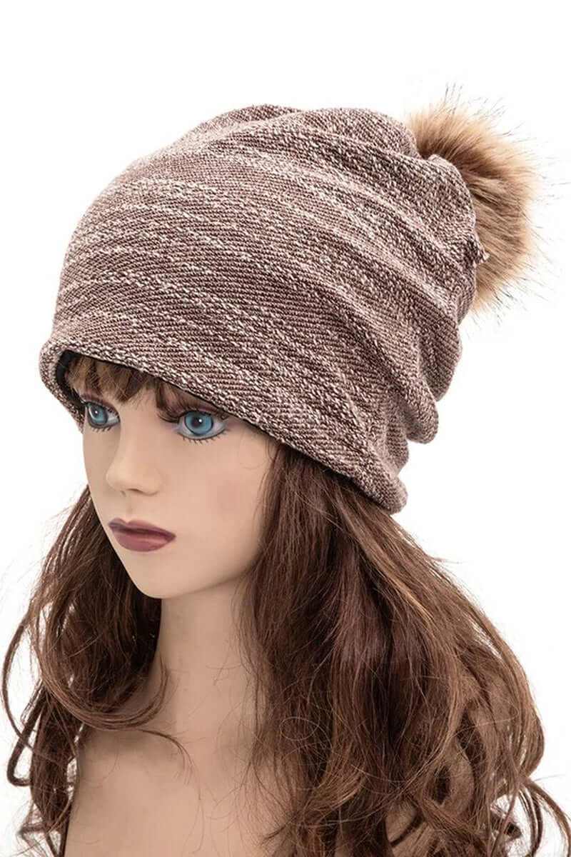 Slouchy cotton blend beanie with faux fur pom, perfect for winter style and warmth.