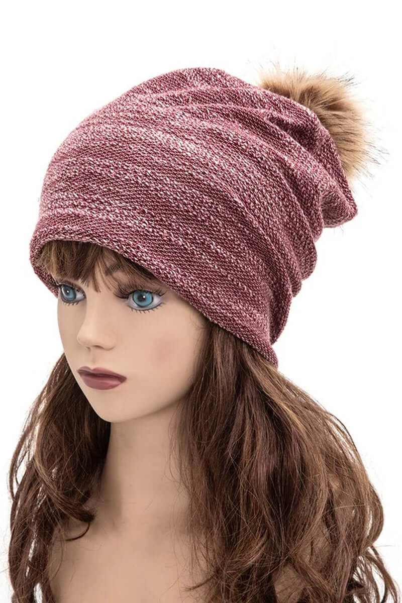 Slouchy cotton blend pom beanie in pink, featuring a fluffy faux fur pom for a stylish winter look.