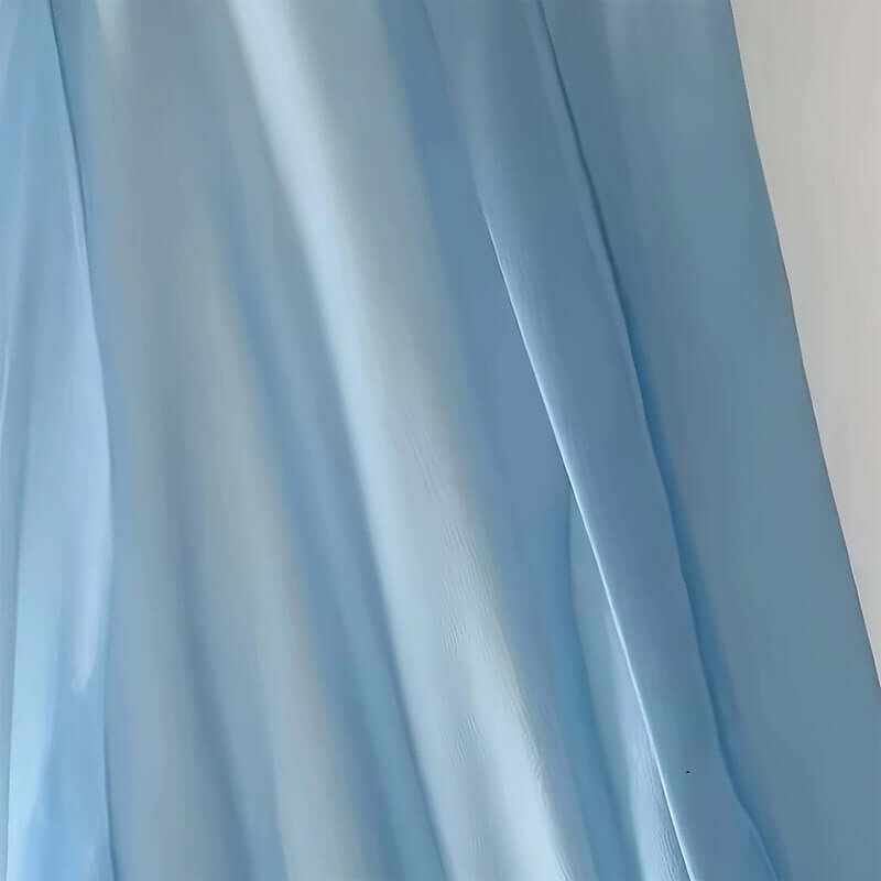 Light blue fabric draping elegantly, showcasing a soft and flowy texture ideal for spring and summer wear.