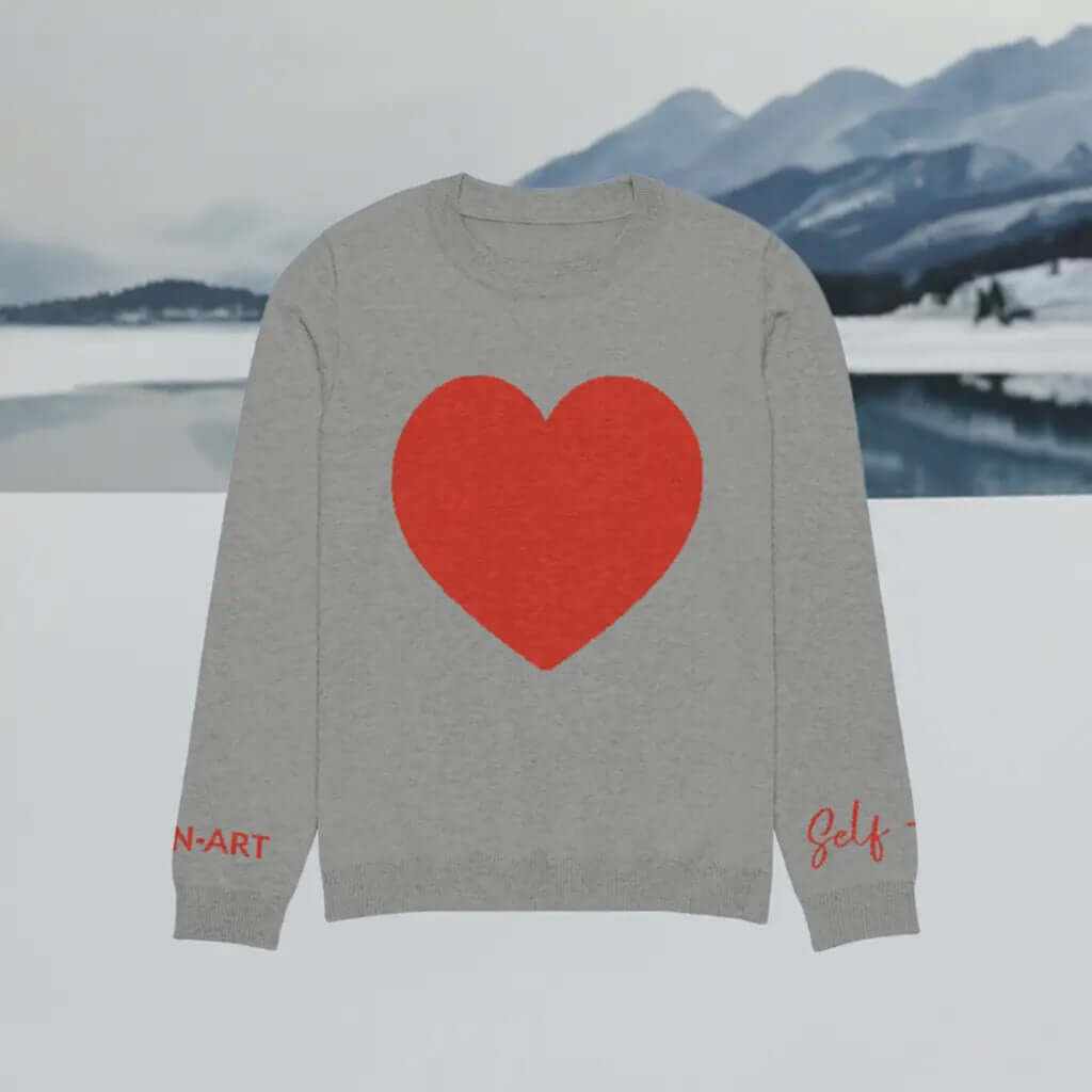 Soft cozy grey crew neck sweater featuring a large red heart design, perfect for casual or dressy occasions.