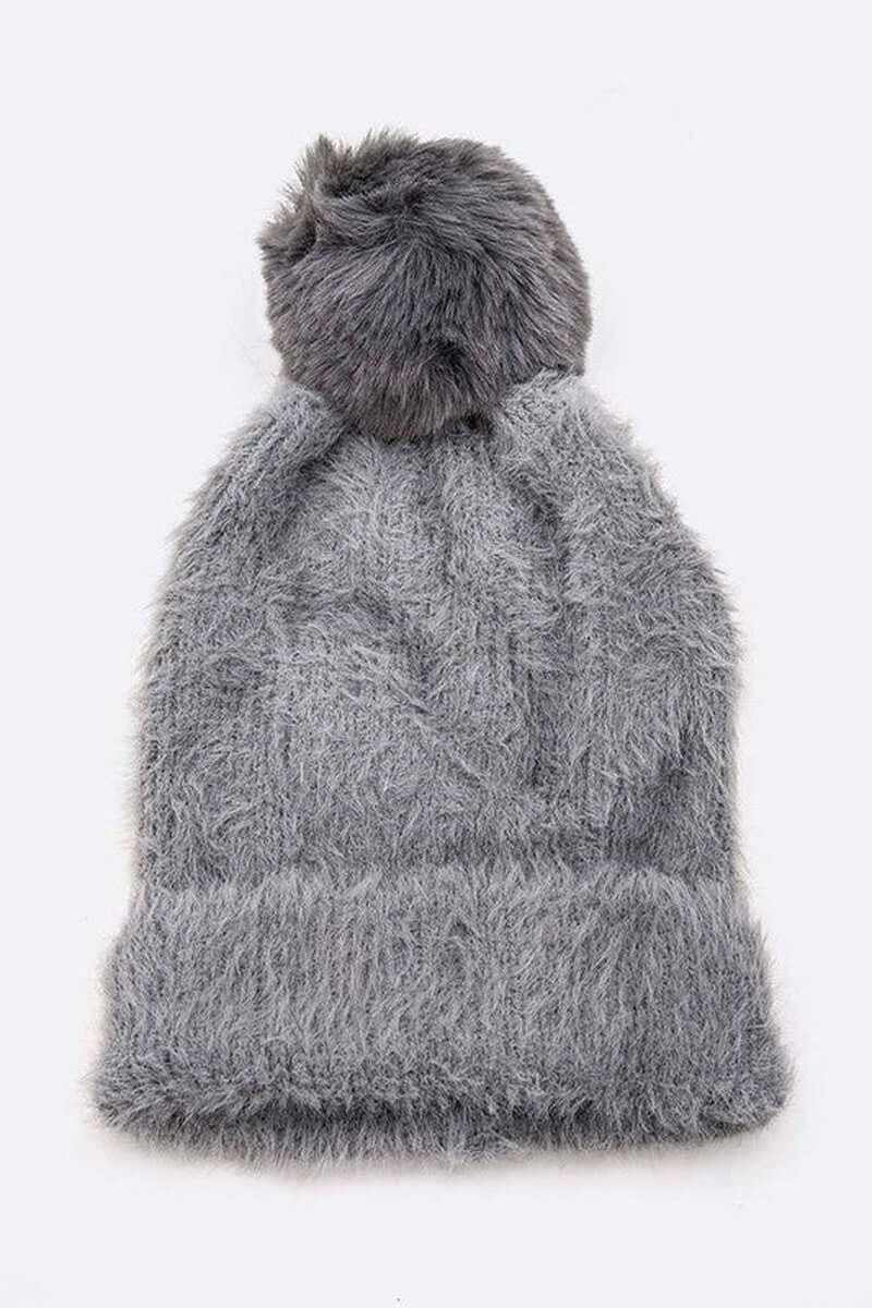 Soft cozy gray mohair beanie with faux fur pom, perfect for winter fashion and warmth.