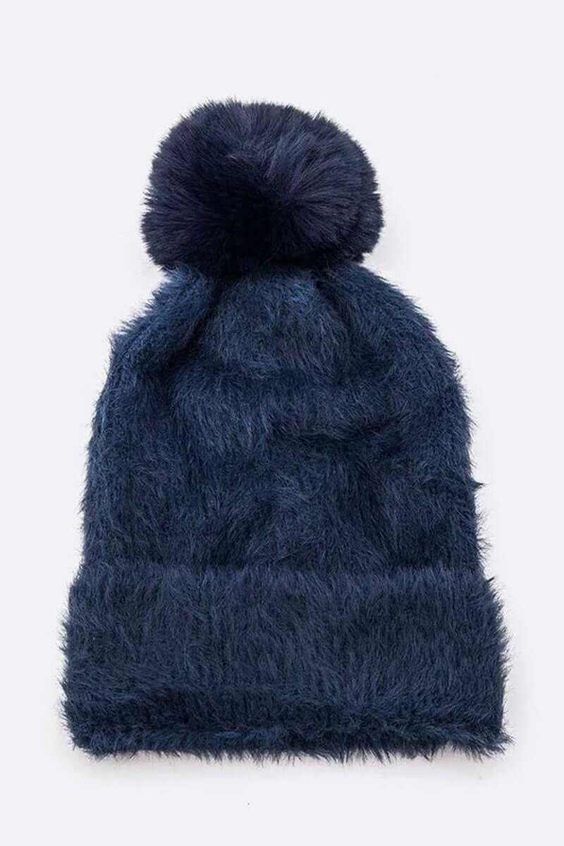 Navy blue soft cozy mohair beanie with fluffy faux fur pom for winter fashion.
