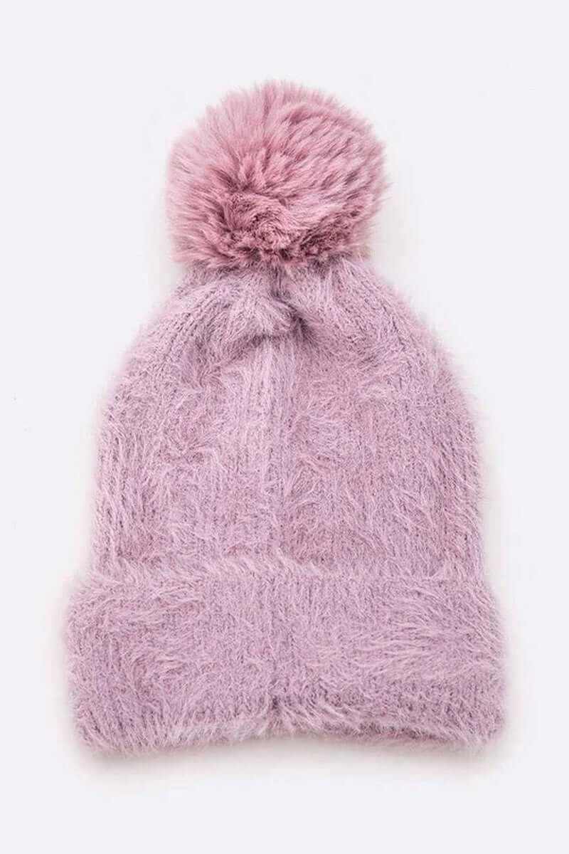 Soft cozy pink mohair faux fur pom beanie, perfect for winter fashion and warmth.