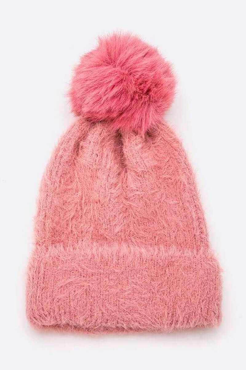 Soft cozy pink mohair beanie with fluffy faux fur pom for winter warmth and style.