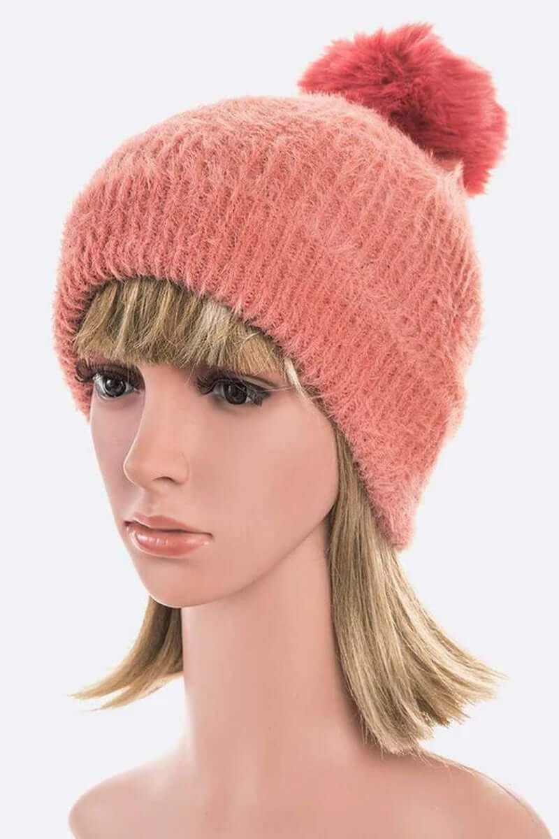 Soft cozy mohair faux fur pom beanie in pink, modeled by mannequin for winter fashion.