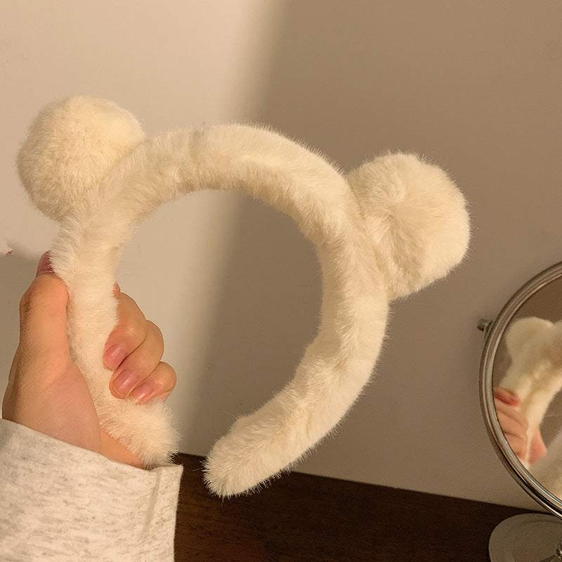 Milky white Spa Essential Cartoon Hair Tie headband with fluffy bear ears, held by hand