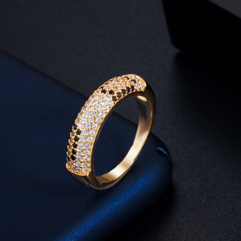 Gold sparkling rhinestone zircon fashion ring with flower shape design on dark background