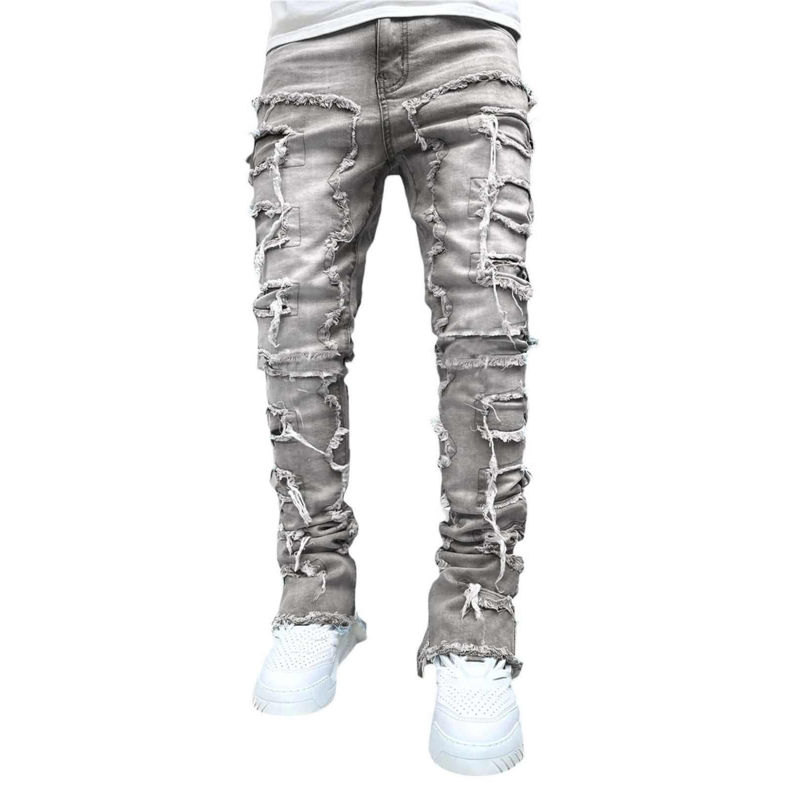 Gray ripped stacked jeans for men with white sneakers on white background