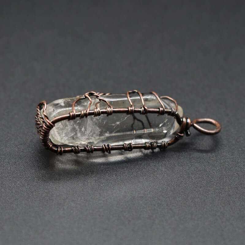 Stylish crystal stone pendant wrapped in copper wire, showcasing a unique and elegant design for fashion necklaces.