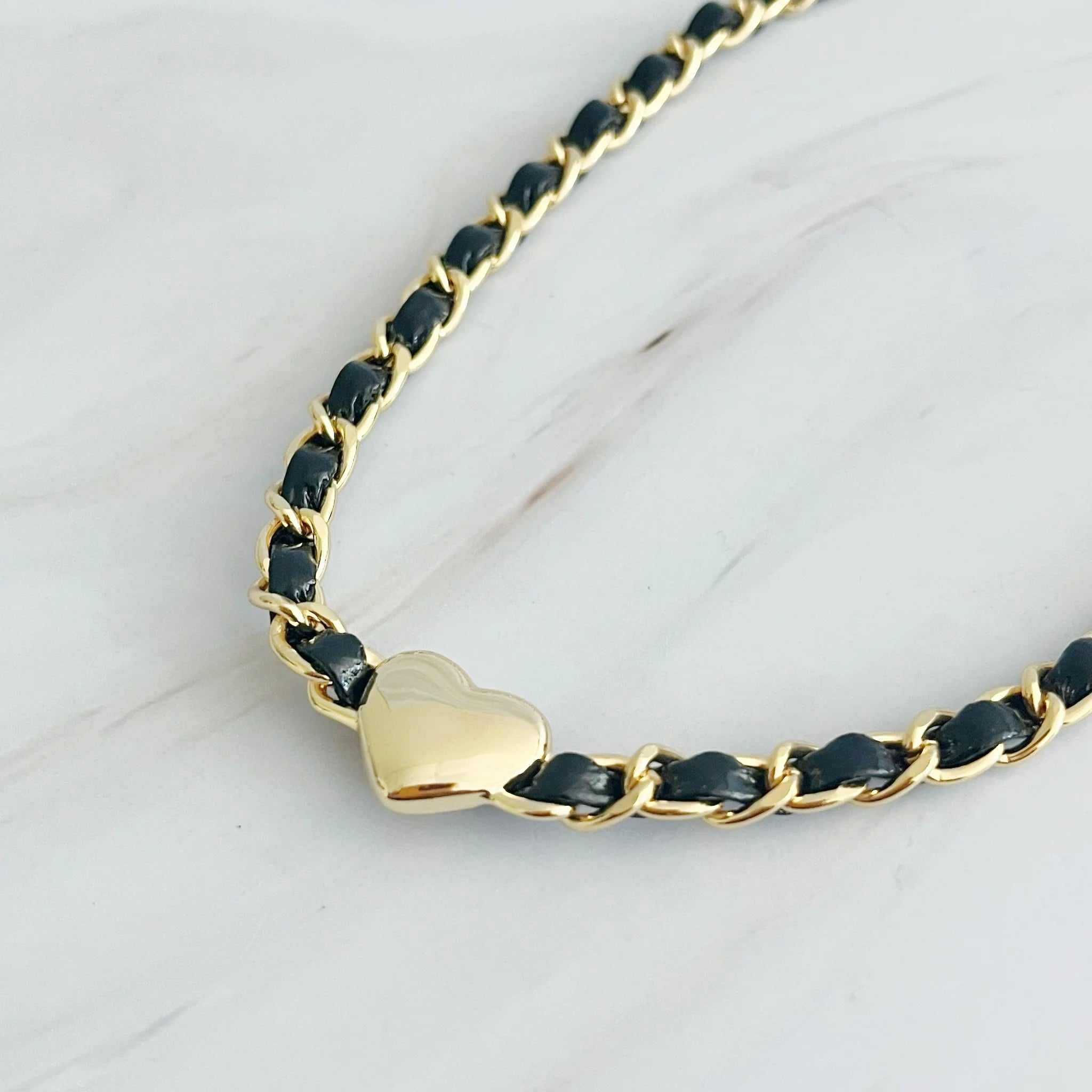 Close-up of Streetwear Edgy Heart Chain Choker Necklace featuring gold heart design and black chain.