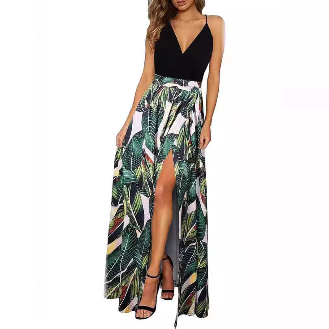 Woman wearing stylish V-neck wrap spaghetti strap dress with tropical leaf print long skirt and high waist slit detail