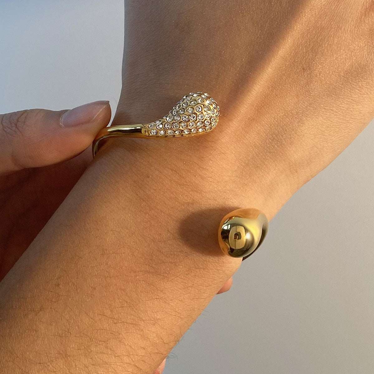 Gold titanium steel bracelet with diamond water drop design on wrist