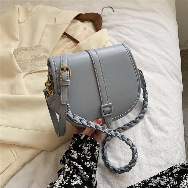 Elegant gray PU women’s saddle messenger purse with braided strap, ideal for any stylish occasion.
