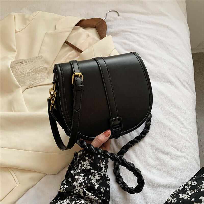 PU stylish trendy women’s saddle messenger purse in black, highlighting braided strap and modern design.