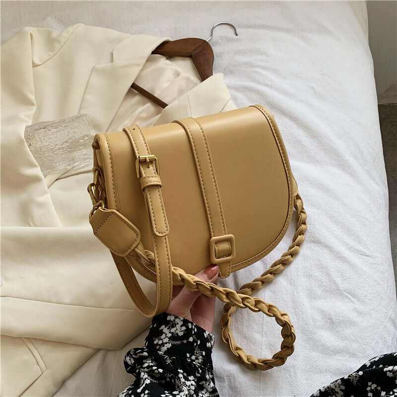 Stylish women's PU saddle messenger purse in mustard color, paired with a chic outfit, perfect for any occasion.