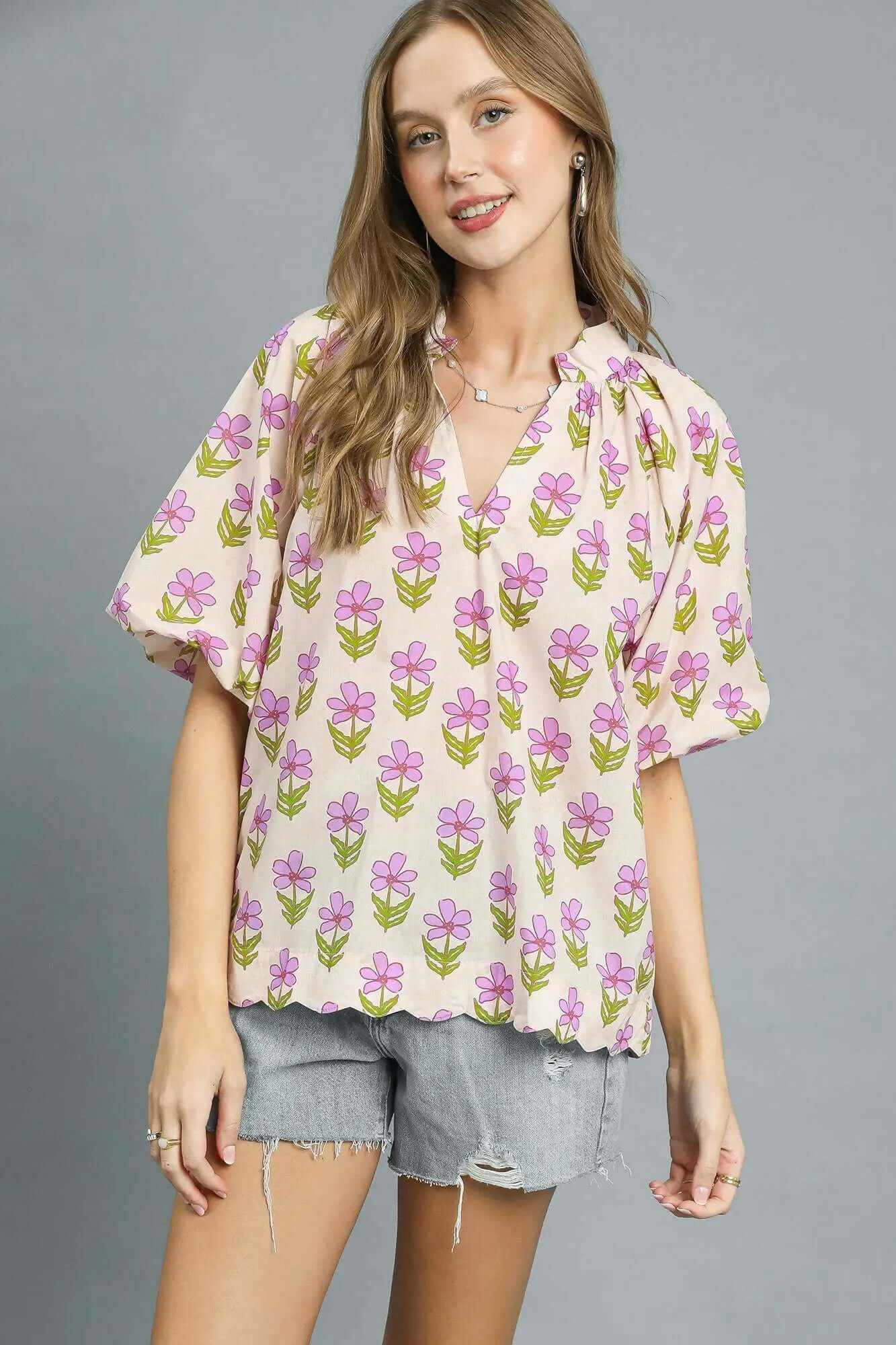 Umgee floral print puff sleeve blouse in soft pink and green tones, featuring a V-neckline and relaxed fit.