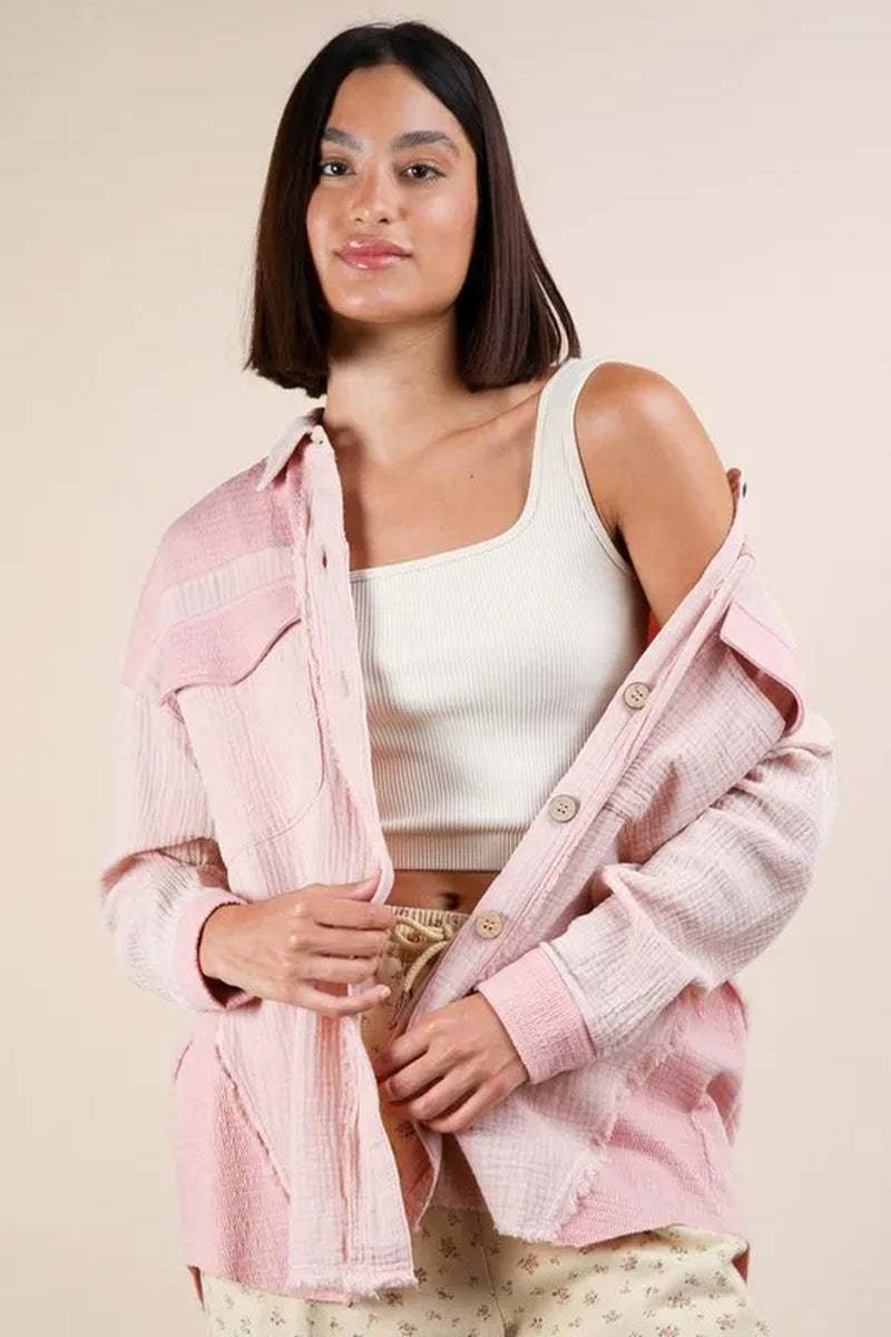 Model wearing a very J mineral washed oversized gauze shacket in pink, paired with a white tank top and casual pants.