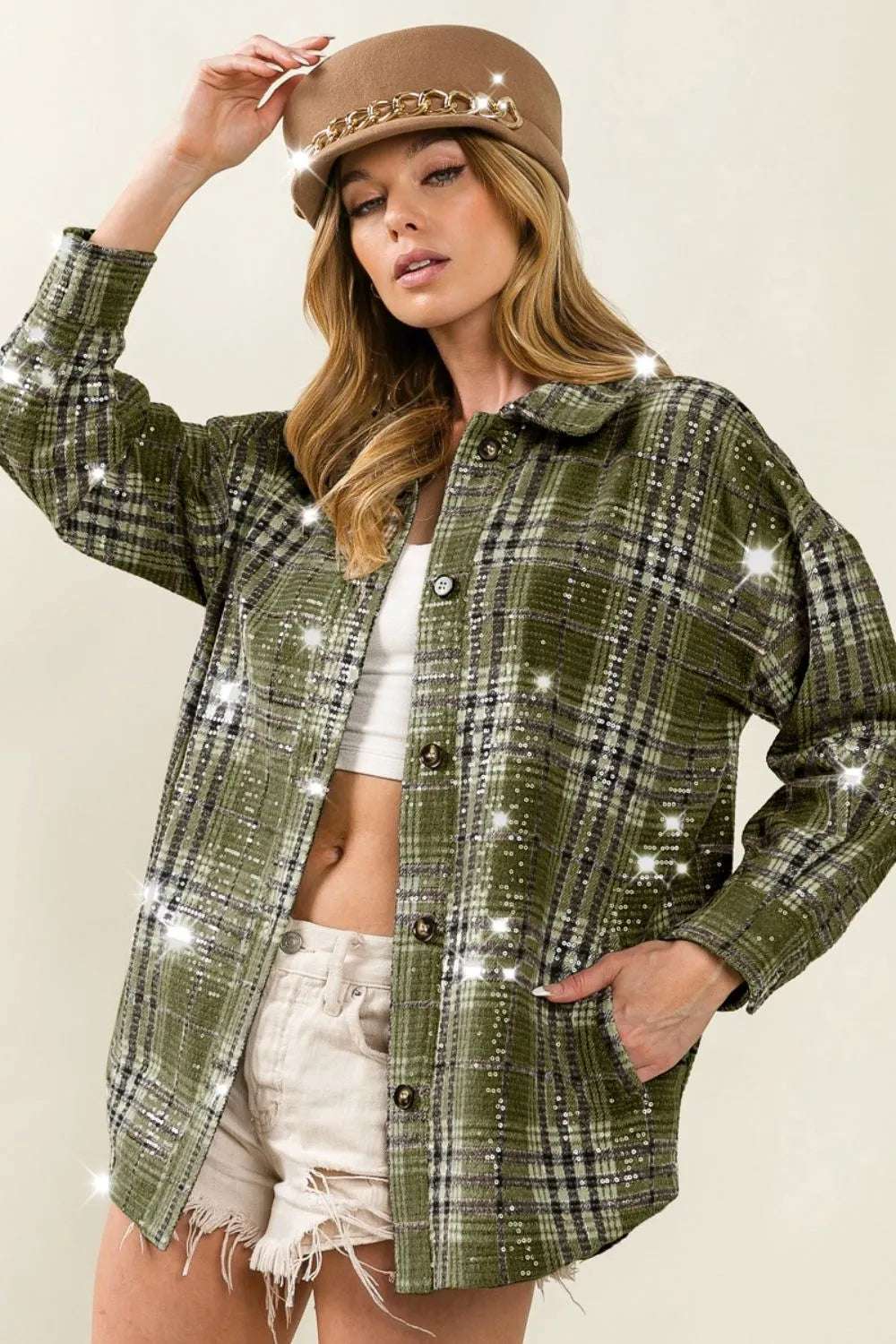 Vintage plaid sparkle jacket for women with sequins, styled with a trendy hat and casual shorts.