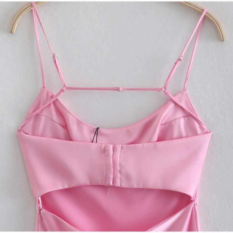 Close-up of pink satin camisole strap details on back of elegant sleeveless summer dress.