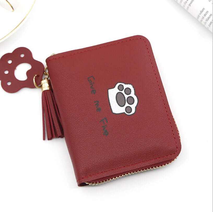 Red zipper wallet with cute cat paw design and tassel accessory, ideal for cat lovers and everyday use.