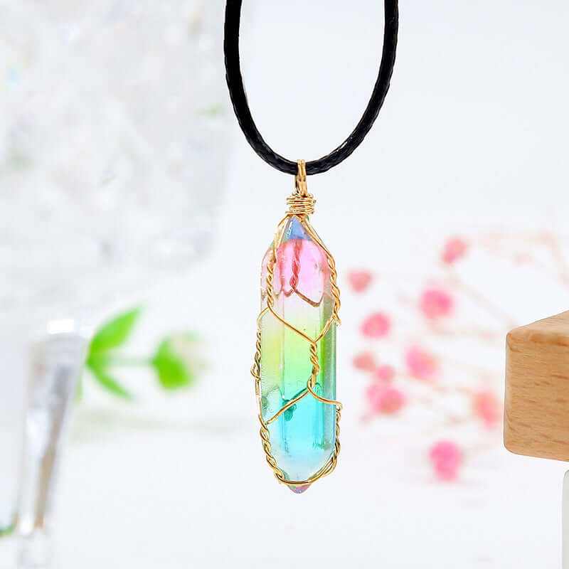 Colorful geometric crystal pendant necklace with gold wire wrapping on a black cord.
