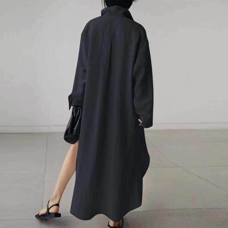 Back view of a woman wearing a stylish black long-sleeved cardigan dress, showcasing its unique design and irregular hem.