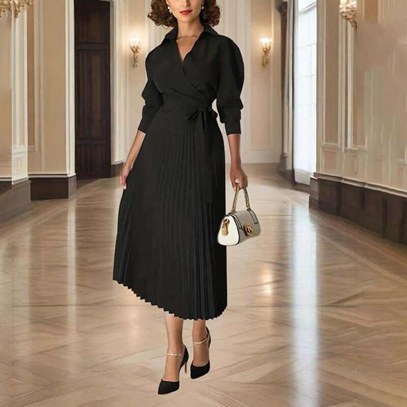 Elegant women's black pleated maxi dress with tie waist, perfect for casual and formal occasions in a sophisticated setting.
