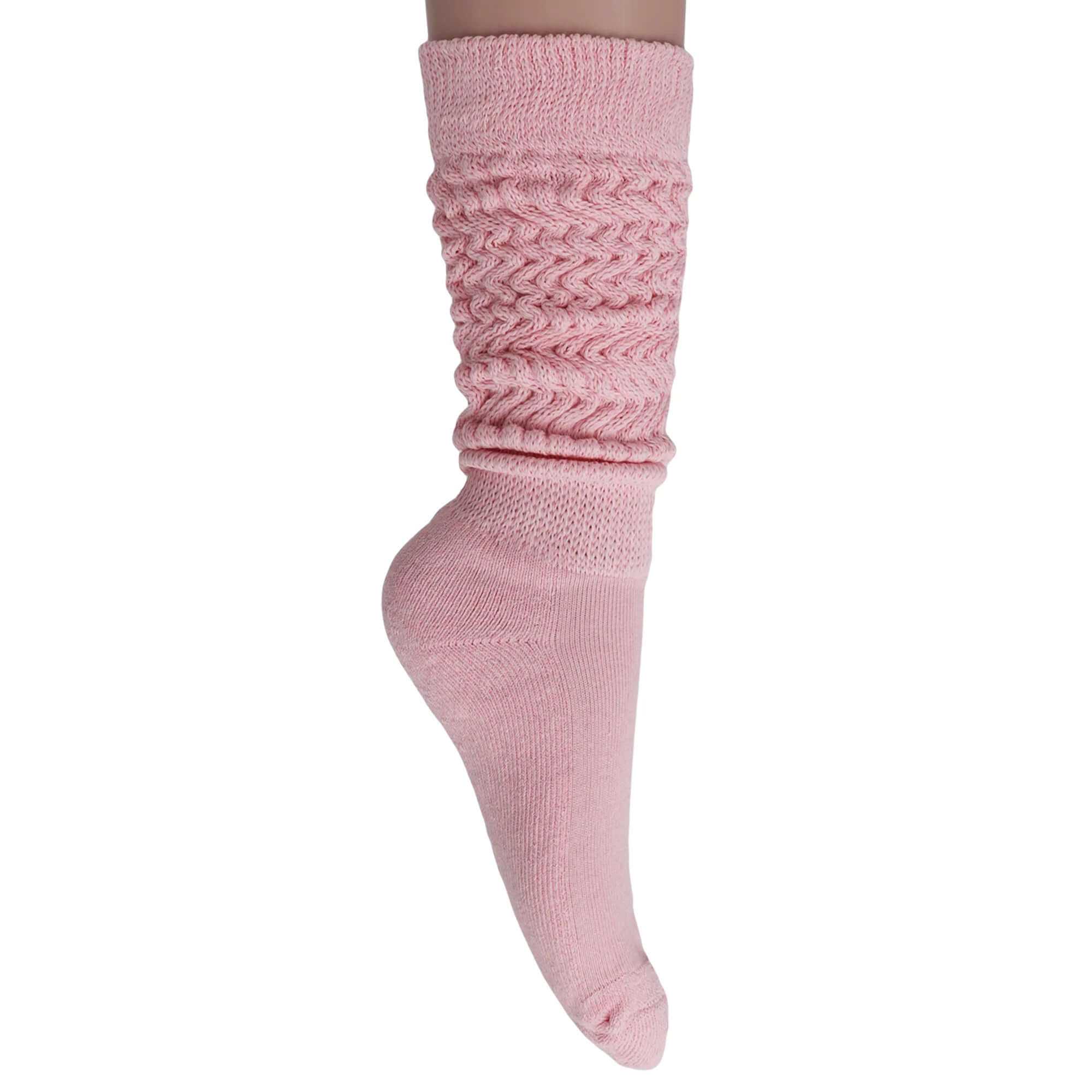 Women's slouchy scrunch socks in soft pink cotton, knee-high style, perfect for casual and retro fashion.