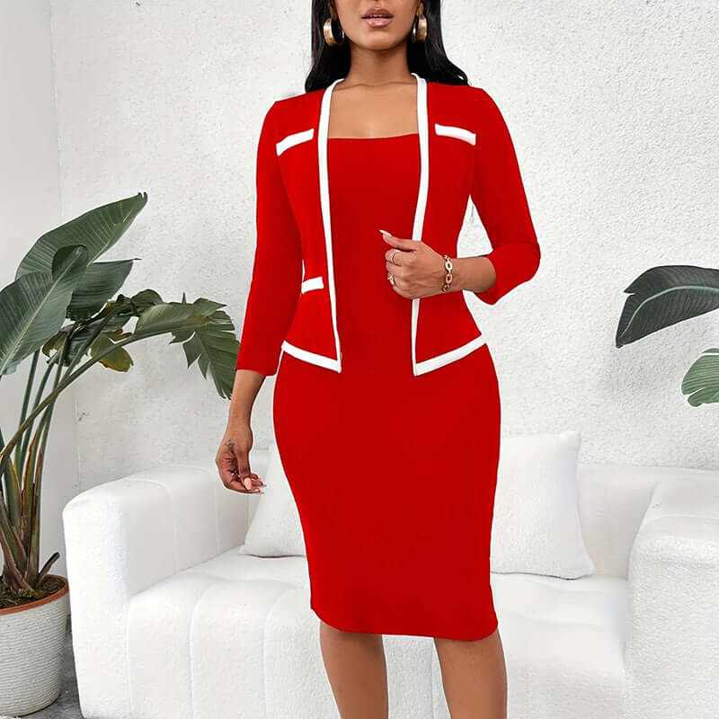 Woman wearing red mock two-piece office dress with half sleeves and white trim standing in modern living room
