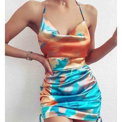 Women's colorful backless suspender mini dress with a tie-dye pattern, perfect for summer outings.