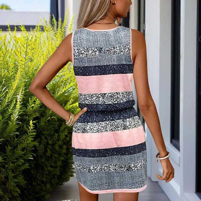 woman wearing colorful striped sleeveless wrap dress with adjustable waist tie outdoors