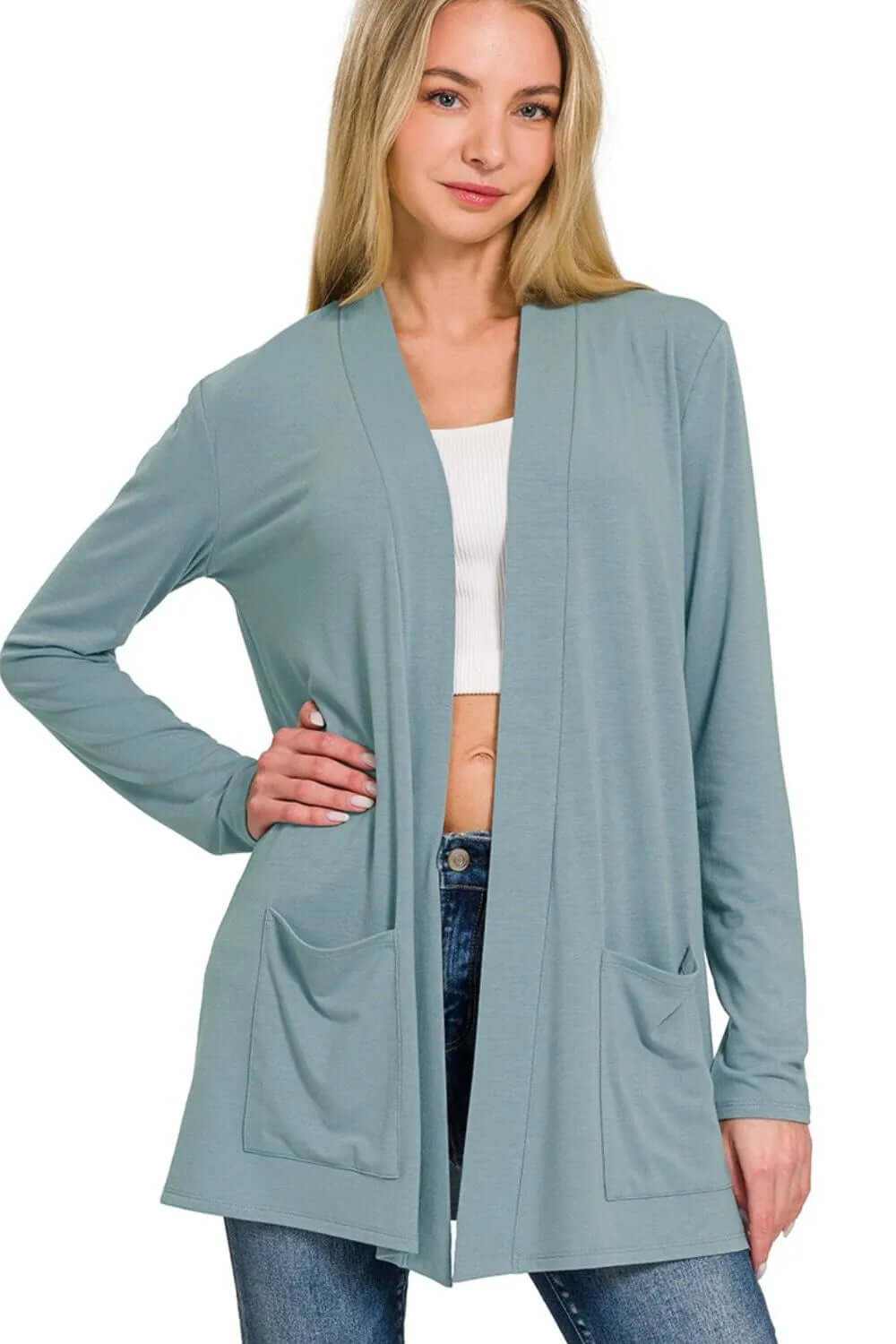 Lightweight slouchy open front pocket cardigan in blue, styled for a casual look with jeans and a simple top.