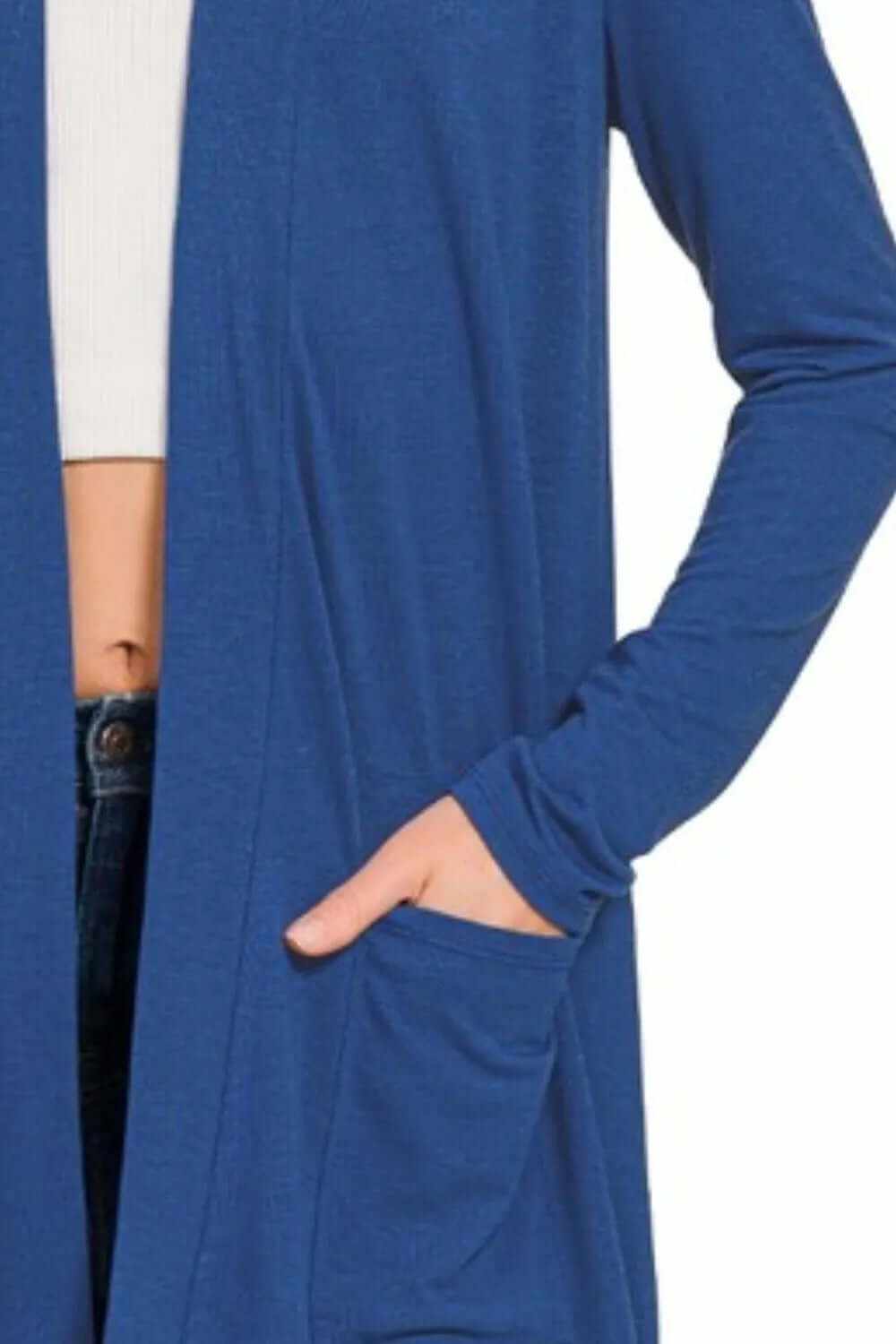 Close-up of a blue slouchy lightweight open front cardigan with pockets, perfect for casual layering.