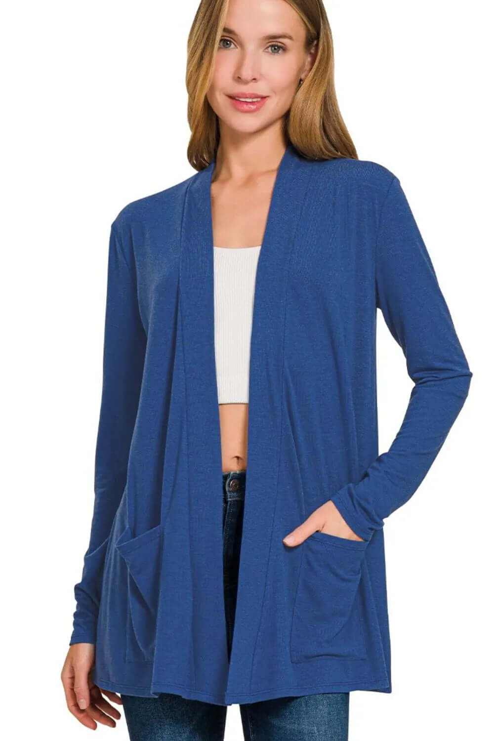 Model wearing a slouchy lightweight open front pocket cardigan in blue, perfect for casual layering.