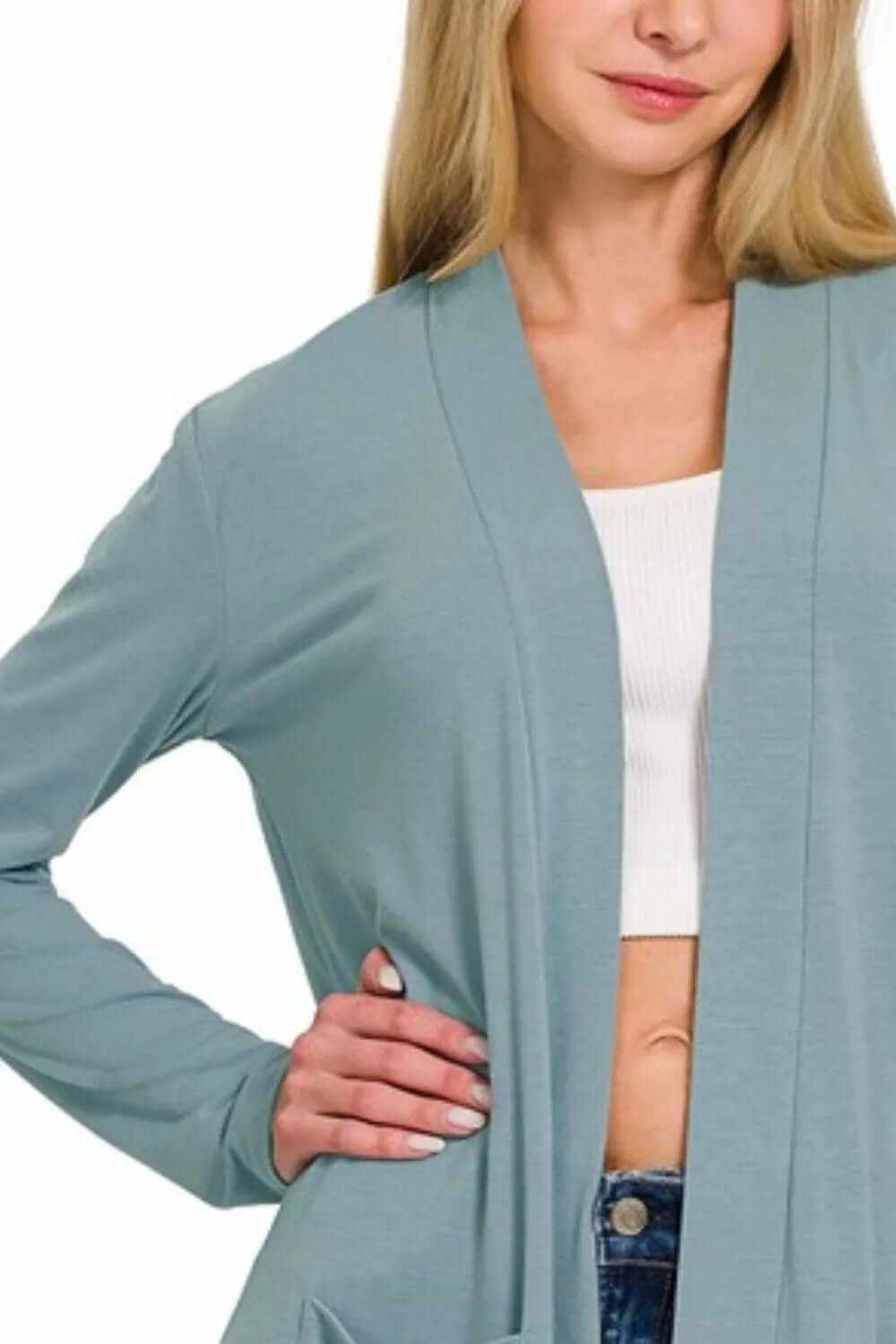 Woman wearing a Zenana Slouchy Lightweight Open Front Pocket Cardigan in soft blue, showcasing casual style and comfort.