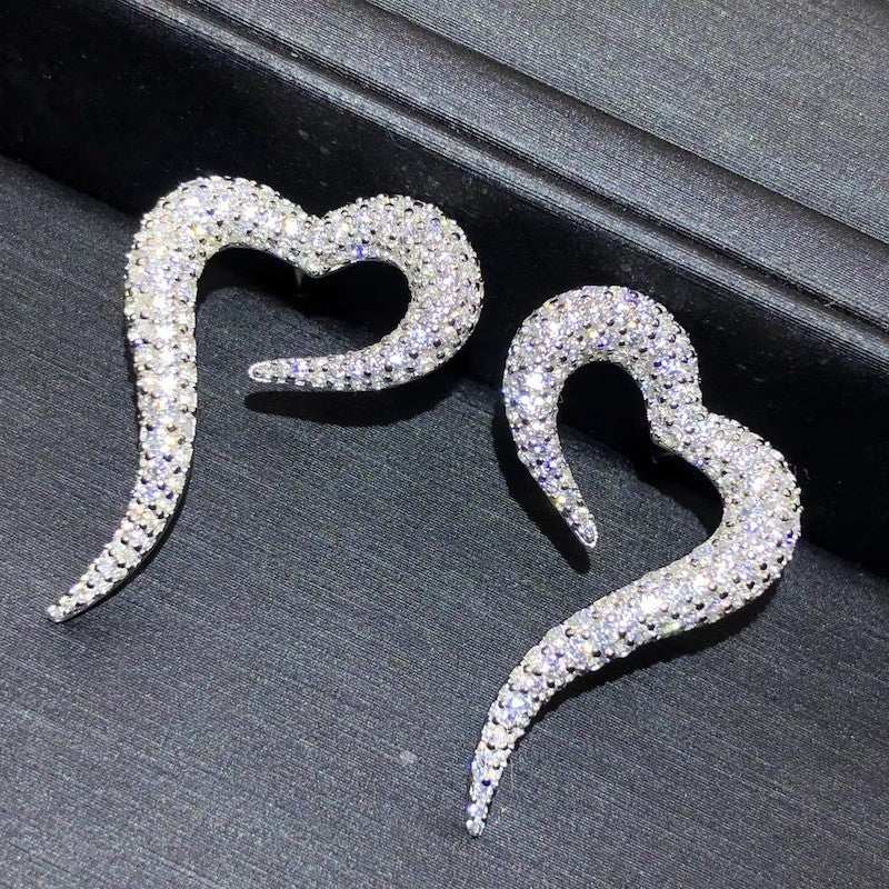 Heart-shaped zircon stud earrings in white gold color with copper material and shiny inlaid zircon design for women.